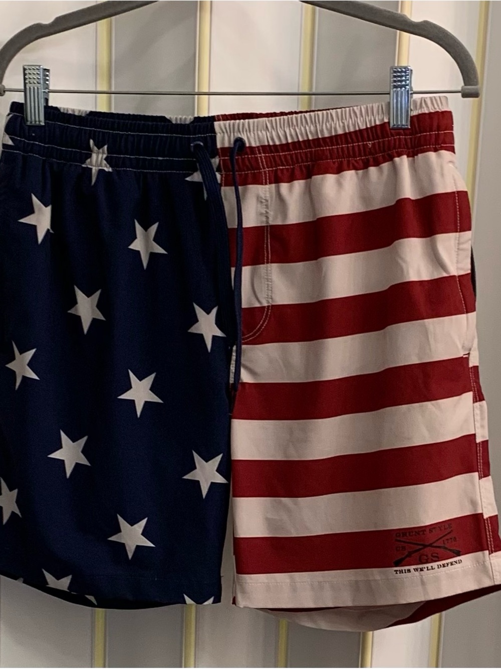 Grunt Style American Flag Swimwear with Moto “This We’ll Defend” on Left Leg